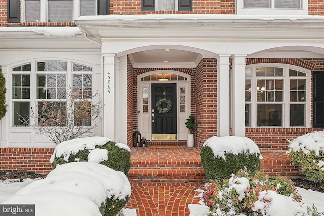 view of snow covered property entrance