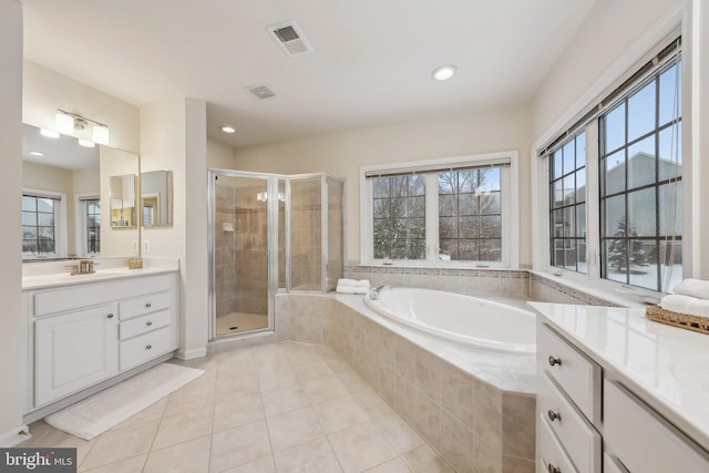 bathroom featuring vanity, tile patterned flooring, and plus walk in shower