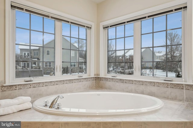 bathroom featuring tiled tub