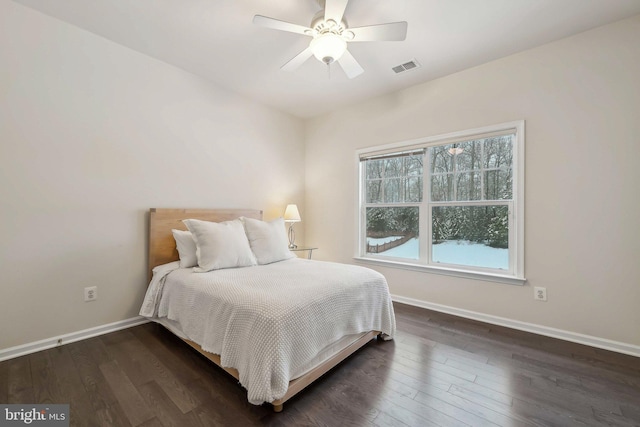 bedroom with ceiling fan and dark hardwood / wood-style flooring