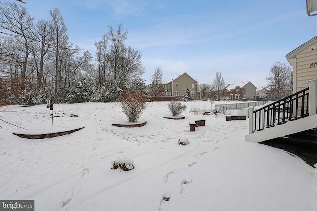 yard layered in snow featuring a wooden deck