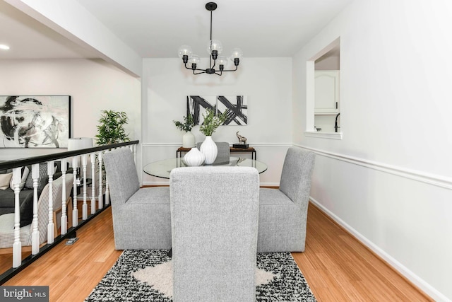 dining area featuring a notable chandelier and light hardwood / wood-style floors