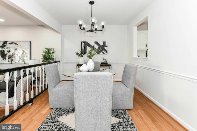 dining space featuring a chandelier and light hardwood / wood-style flooring