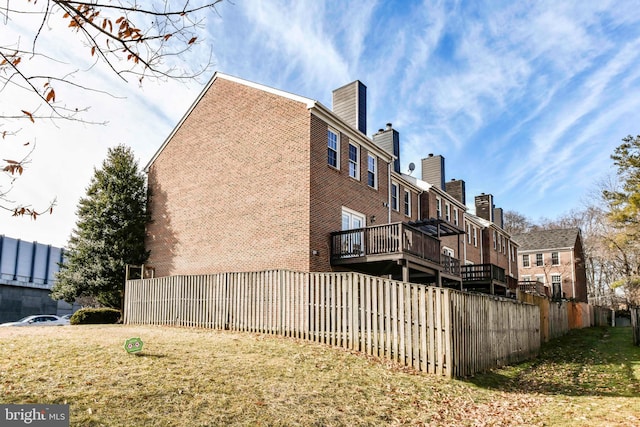 view of side of property with a lawn