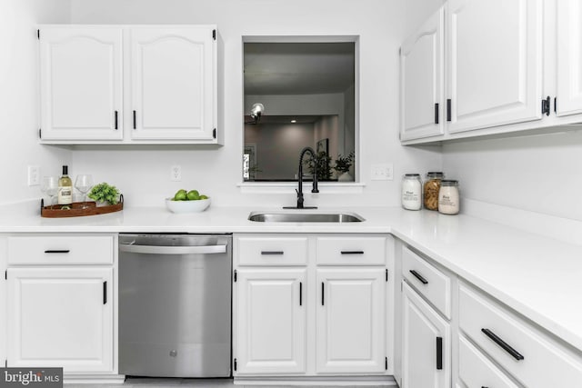 kitchen with white cabinetry, dishwasher, and sink