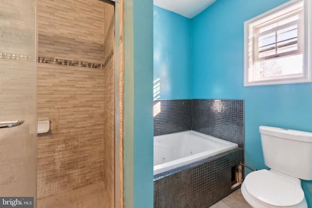 bathroom with a relaxing tiled tub and toilet