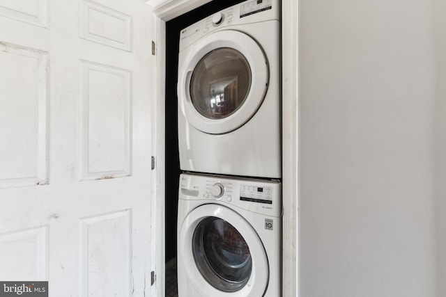 laundry area with stacked washer / drying machine