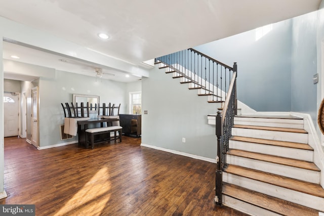 stairway with wood-type flooring and ceiling fan