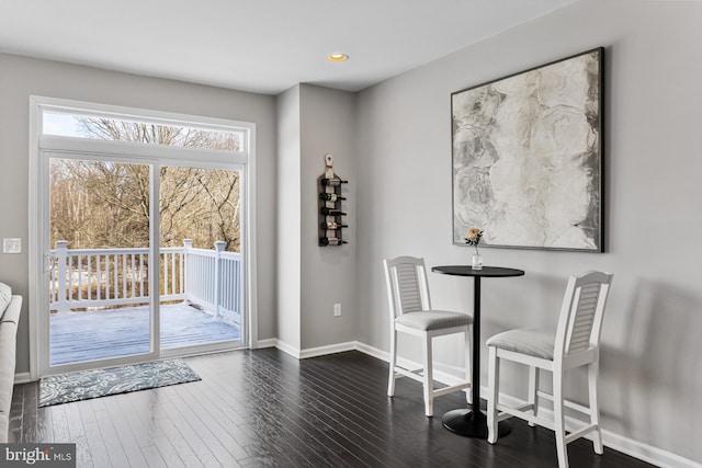 dining space with dark wood-type flooring