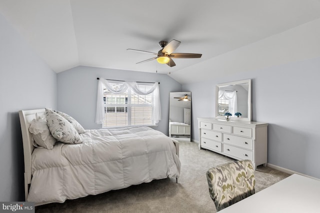 carpeted bedroom featuring lofted ceiling and ceiling fan