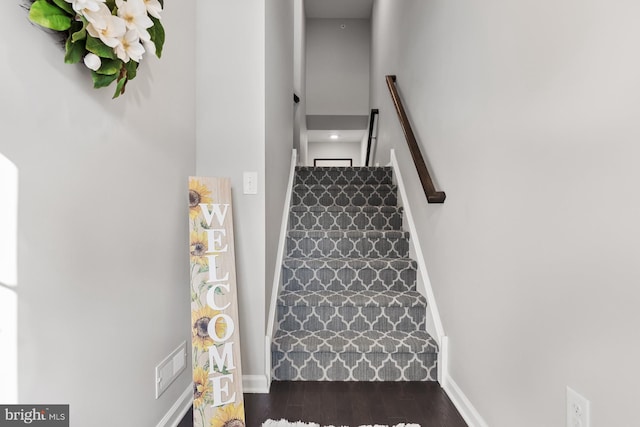 stairs featuring wood-type flooring