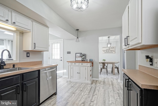 kitchen with white cabinetry, dishwasher, sink, hanging light fixtures, and light hardwood / wood-style floors