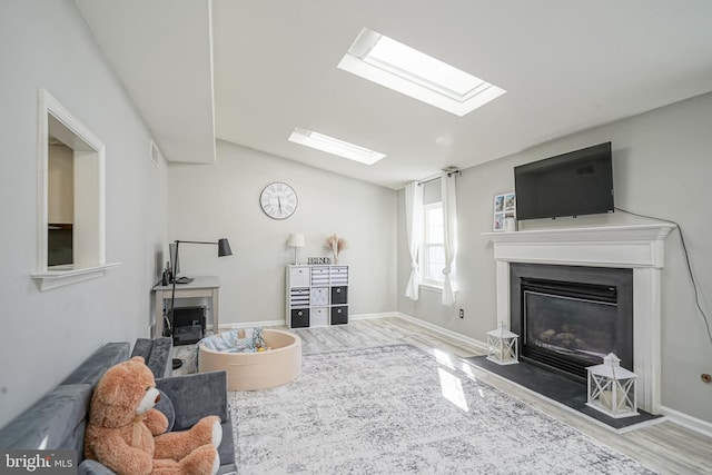 living room featuring vaulted ceiling and light hardwood / wood-style floors