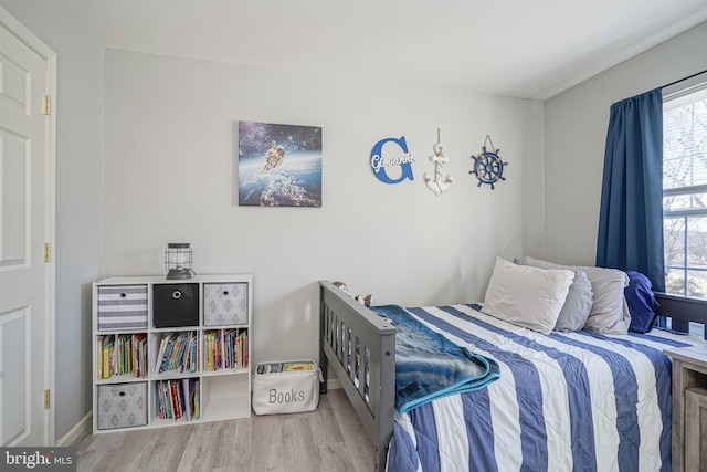 bedroom with hardwood / wood-style flooring