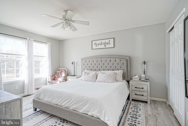 bedroom featuring ceiling fan, light wood-type flooring, and a closet