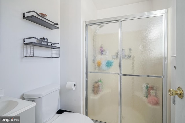 bathroom with walk in shower, vanity, and toilet