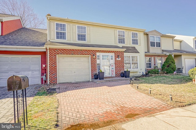 view of front of property with a garage, central AC, and a front yard