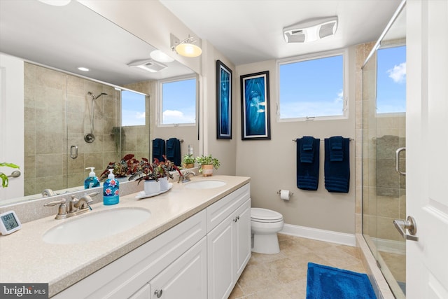 bathroom featuring tile patterned flooring, an enclosed shower, vanity, and toilet