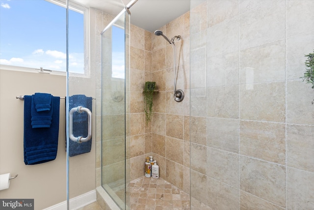 bathroom featuring a shower with shower door