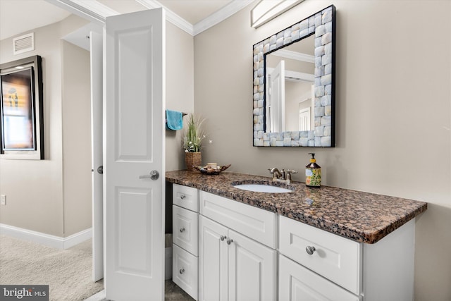 bathroom featuring crown molding and vanity