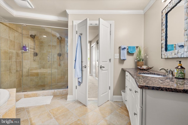 bathroom with ornamental molding, vanity, and a shower with shower door