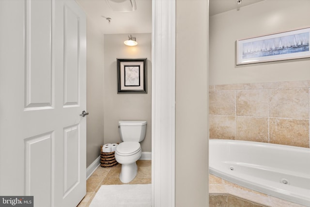 bathroom featuring tile patterned flooring, a relaxing tiled tub, and toilet