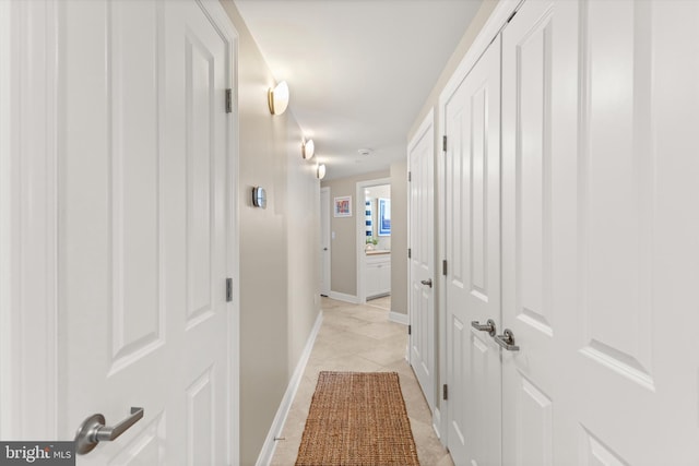 hall featuring light tile patterned floors