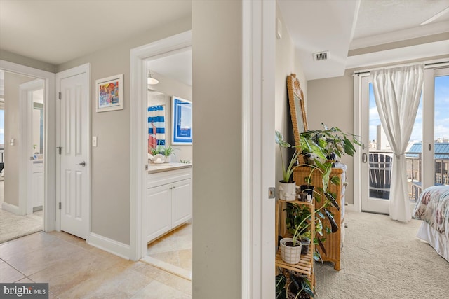 corridor featuring light colored carpet