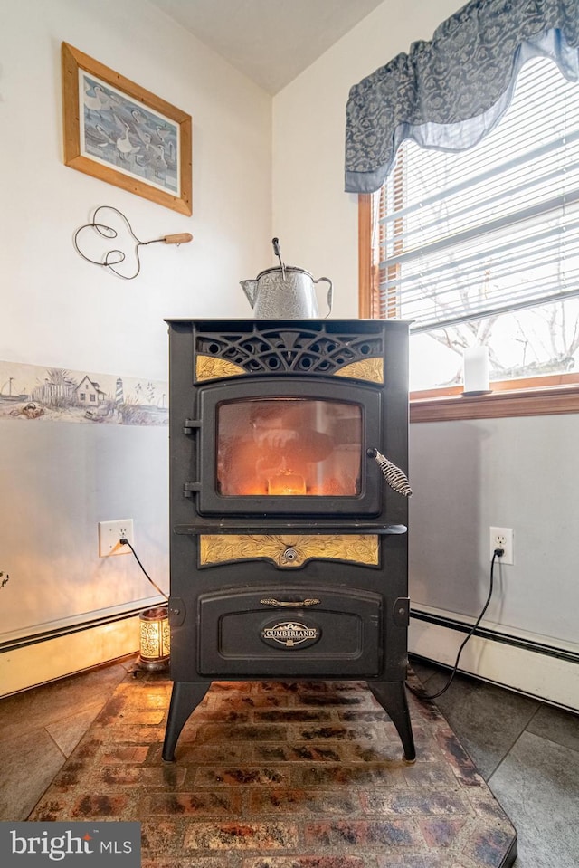 room details featuring a wood stove and a baseboard radiator