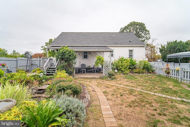 rear view of house with a patio area and a yard