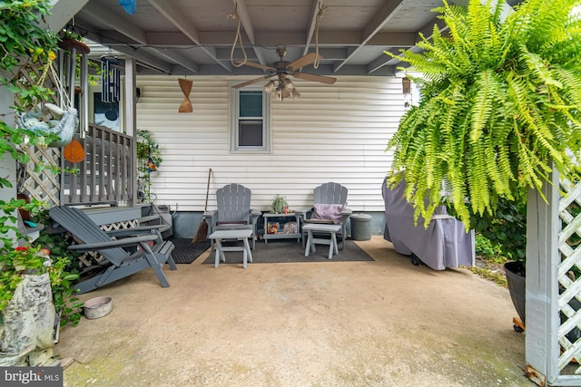 view of patio / terrace with a fire pit and ceiling fan