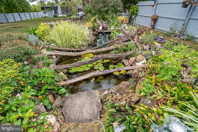 view of yard featuring a small pond