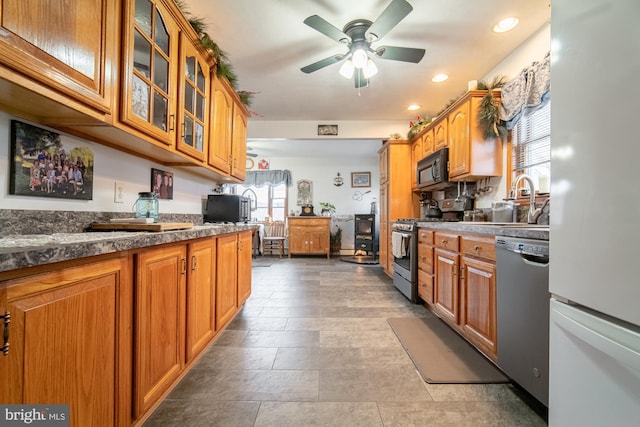 kitchen featuring appliances with stainless steel finishes, ceiling fan, and sink