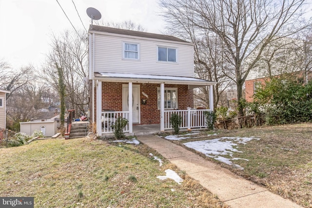 view of property featuring a front lawn and a porch