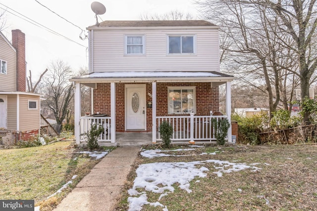 front facade with a porch and a front lawn