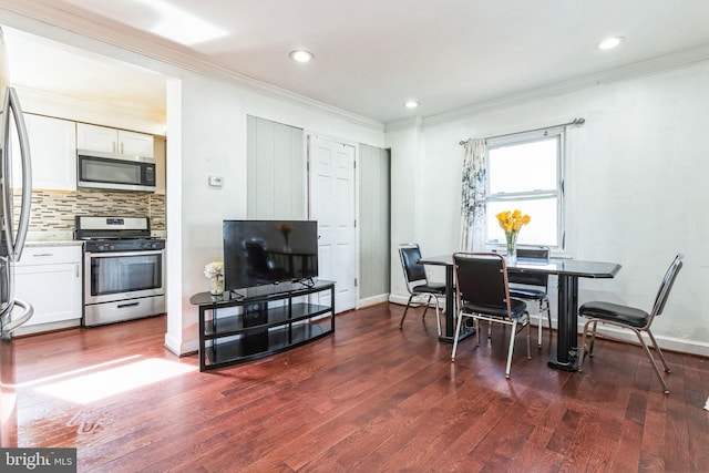 dining area with crown molding and dark hardwood / wood-style floors