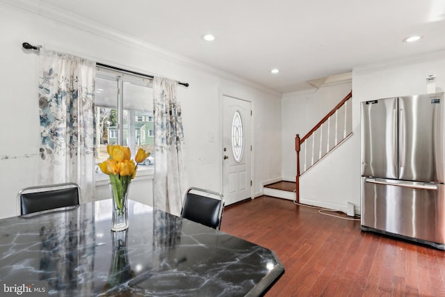 dining room with crown molding and dark hardwood / wood-style flooring