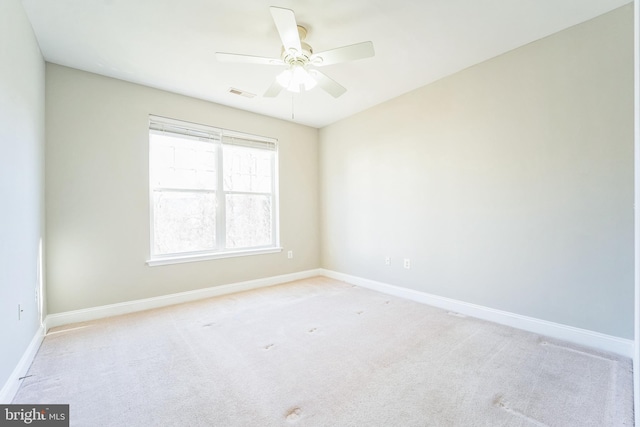 unfurnished room with ceiling fan and light carpet