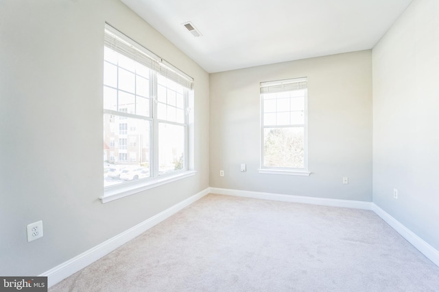 unfurnished room featuring light colored carpet