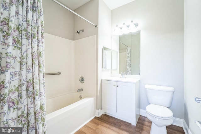 full bathroom with hardwood / wood-style flooring, shower / tub combo with curtain, vanity, and toilet