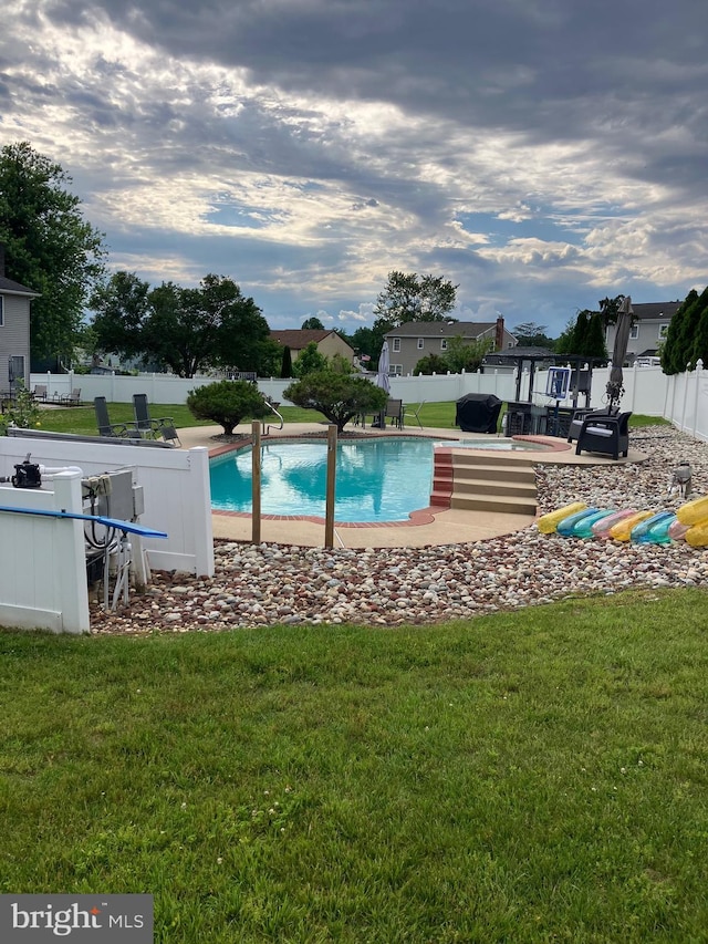 view of pool featuring a yard