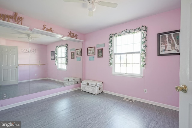 unfurnished room with dark hardwood / wood-style floors and ceiling fan