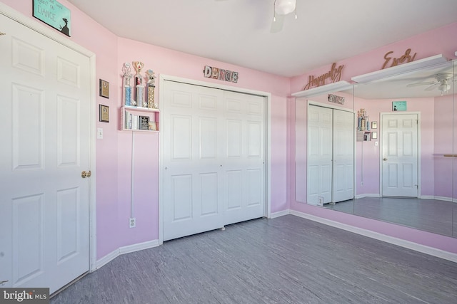 unfurnished bedroom with dark hardwood / wood-style floors and ceiling fan