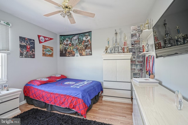 bedroom with light hardwood / wood-style flooring and ceiling fan