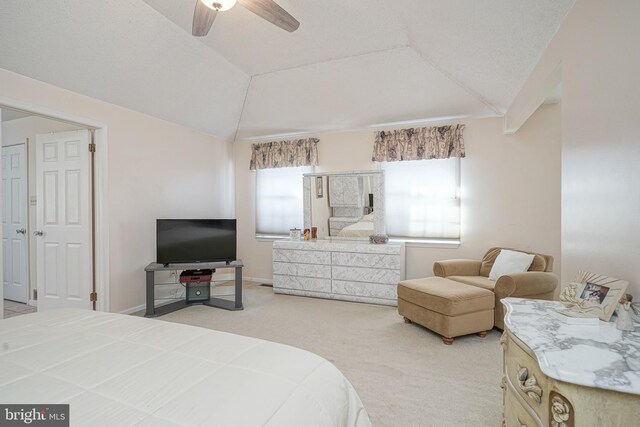 carpeted bedroom with vaulted ceiling and ceiling fan