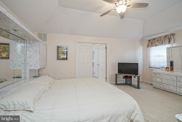 bedroom featuring light carpet, vaulted ceiling, and ceiling fan