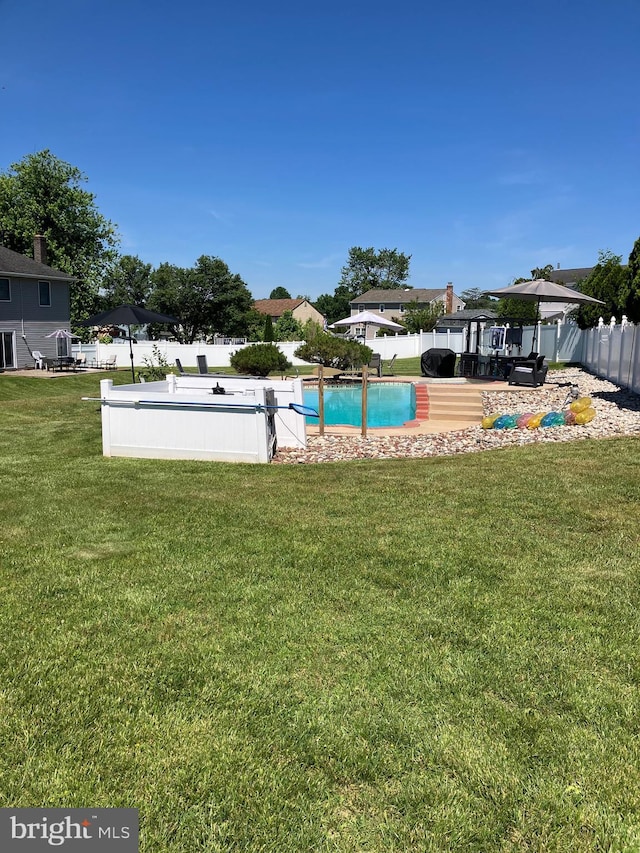 view of swimming pool with a lawn