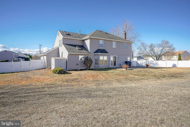 rear view of property with a yard