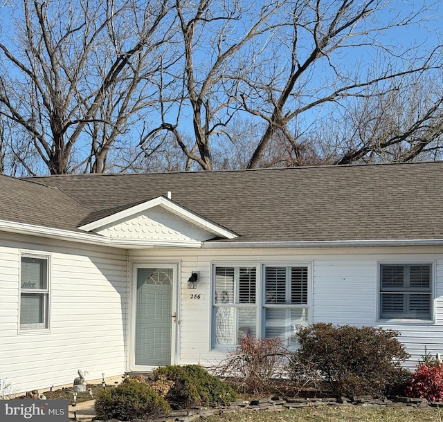 view of front of home with a shingled roof