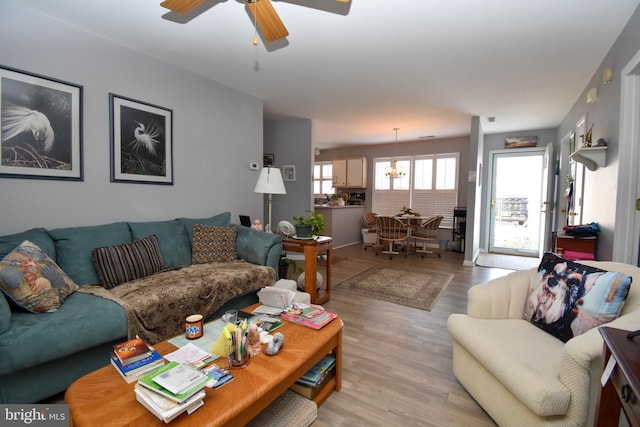 living room with light wood-style flooring and a ceiling fan